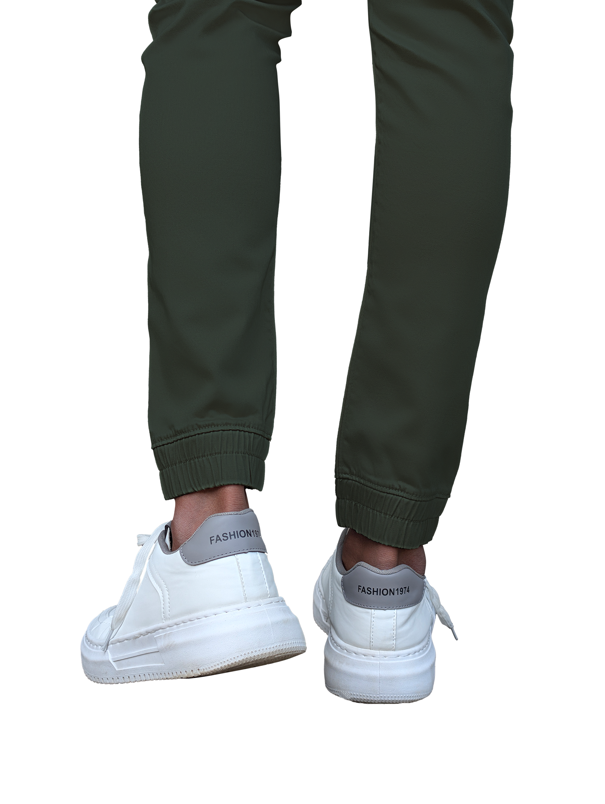 Green jogger pants worn with white sneakers on a white background
