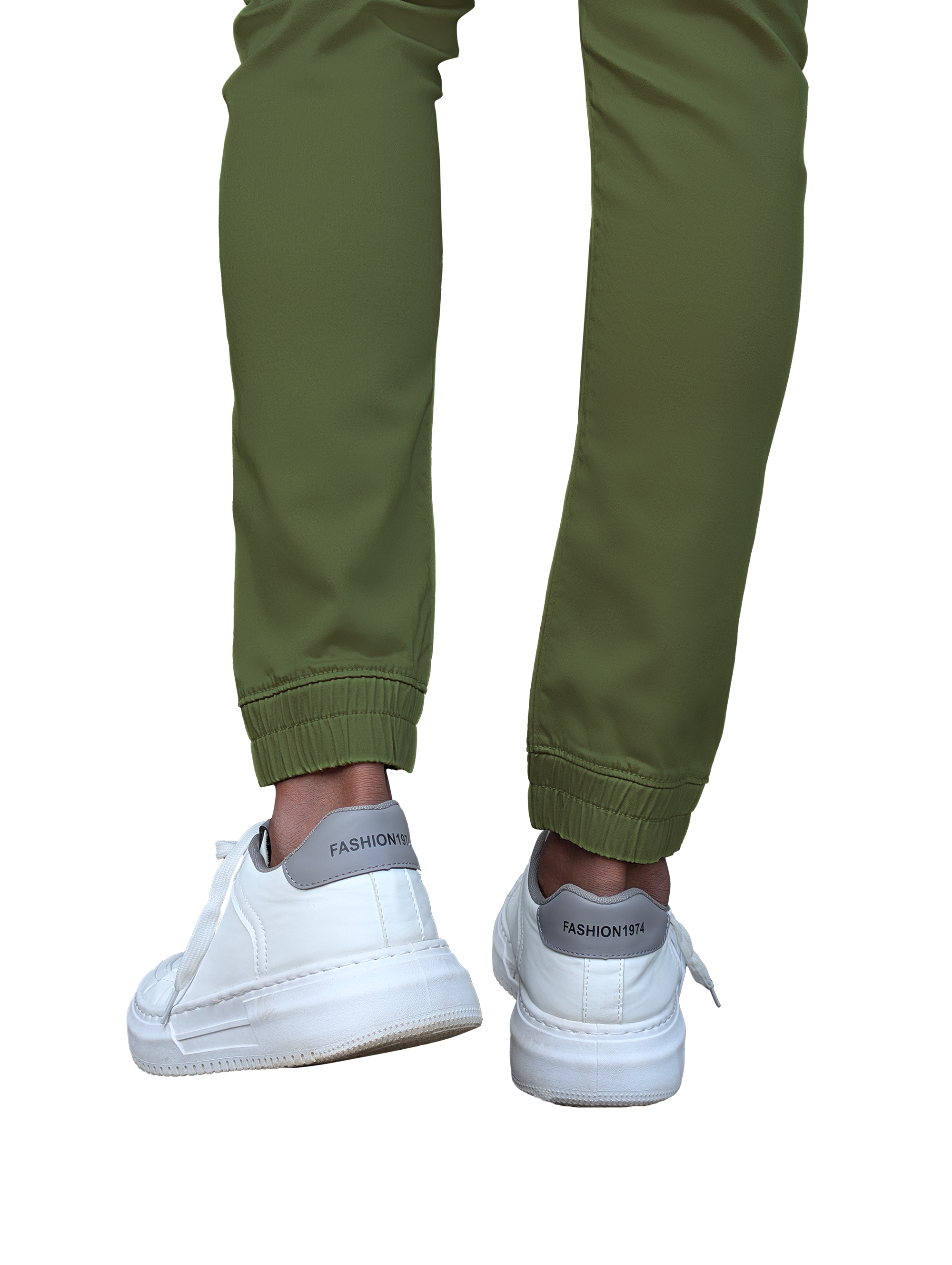 Green jogger pants worn with white sneakers on a white background